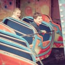 Two happy kids enjoying a day full of excitement and laughter at an amusement park.