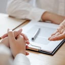 lawyer discussing a legal matter with a client at his law firm, close-up on their hands