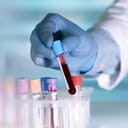 Lab technician handling test tubes