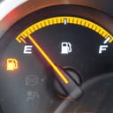 Fuel gauge in a car showing the tank is empty