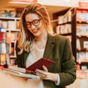 Young woman reading a book she picked from a bookstore shelf in a bookstore