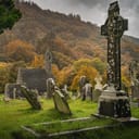 an ancient Glendalough Cemetery with medieval church and Celtic crosses in Wicklow, Ireland