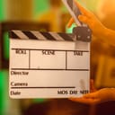 A person holding a movie clapperboard