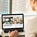Two people browsing Airbnb website on laptop