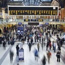 Liverpool street station in the UK at rush hour with all faces blurred out and logos/trademarks removed