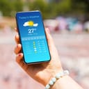 Woman checking out weather forecast on her smartphone