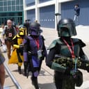 A group of fans dressed in Mandalorian-inspired costumes at Star Wars Celebration IV.