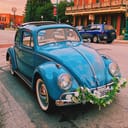 Vintage VW beetle decorated with flowers on the front bumper