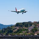 plane flying over the airport on Corfu Island