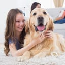 Small girl hugging a family dog