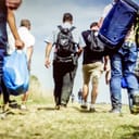 A group of refugees walking along a trail