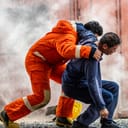Rescue worker helping an injured person to safety