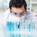 A lab technician measuring liquid for testing