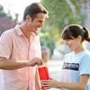 Man donating money to a volunteer holding a donation jar