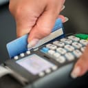 Woman swiping a card through the terminal