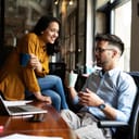 Colleagues in office. Businesswoman and businessman drinking coffee