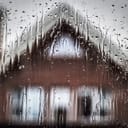 a view of a private home through a wet window on a rainy day
