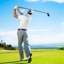 Man playing golf out on the course