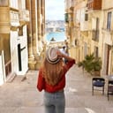 female traveler descending stairs in the historic city of Valletta, a UNESCO World Heritage site in Malta
