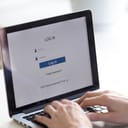 A person using the access window to log in or to create a new web account.