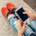 Woman holding an old-school smartphone