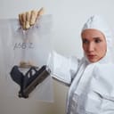 CSI holding an evidence bag with a gun and bullets inside it