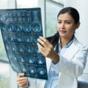 Female doctor inspecting an MRI scan