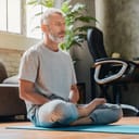 A middle aged man doing yoga in his apartment