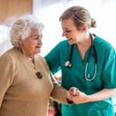 Health visitor talking to a senior woman during home visit