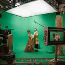 On Big Film Studio Professional Crew Shooting Period Costume Drama Movie. On Set: Director Controls Cameraman Shooting Green Screen Scene with Two Actors Talented Wearing Renaissance Clothes Talking
