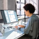 Woman working at a computer filling out an invoice