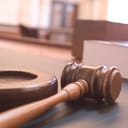 Closeup of a gavel and sound block in court