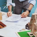 A closeup of an architect checking a blueprint