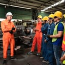 workers attending a meeting in a factory setting