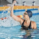 Swimming, success or happy winner in celebration for achievement in race or pool competition. Fitness, wellness or excited woman swimmer winning sports game with victory or championship performance