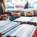 close up of a woman's hands choosing vinyl record in a music shop