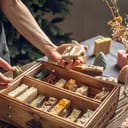 close-up of a woman holding handmade soap with a lot of other pieces in a wooden box