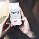close-up of smartphone with a survey on the screen