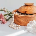 A jewelry box with. pearls falling out of it