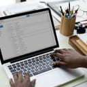 A closeup of a person checking email on a laptop