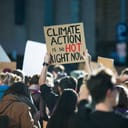A climate activist holding a sign at a protest