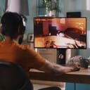 Indian man playing fps game on an expensive PC