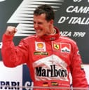 Michael Schumacher as Ferrari driver clutching a fist in celebratory fashion with a grin on his face