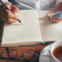 A person noting down a plan in their planner