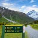 A sign directing to Kea Point, a hiking trail offering views of Muller Glacier and Muller Lakes in Mount Cook National Park, New Zealand.