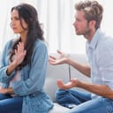 Woman gesturing during an argument with her partner in the living room