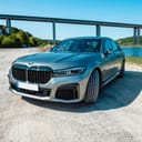 a BMW vehicle stationed on a gray sandy surface