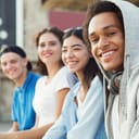 A group of teenagers posing for a close-up photo while seating