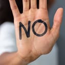 a woman's palm with a 'no' written on it
