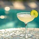 Margarita cocktail served by the poolside, with a slice of lime used as a decoration.